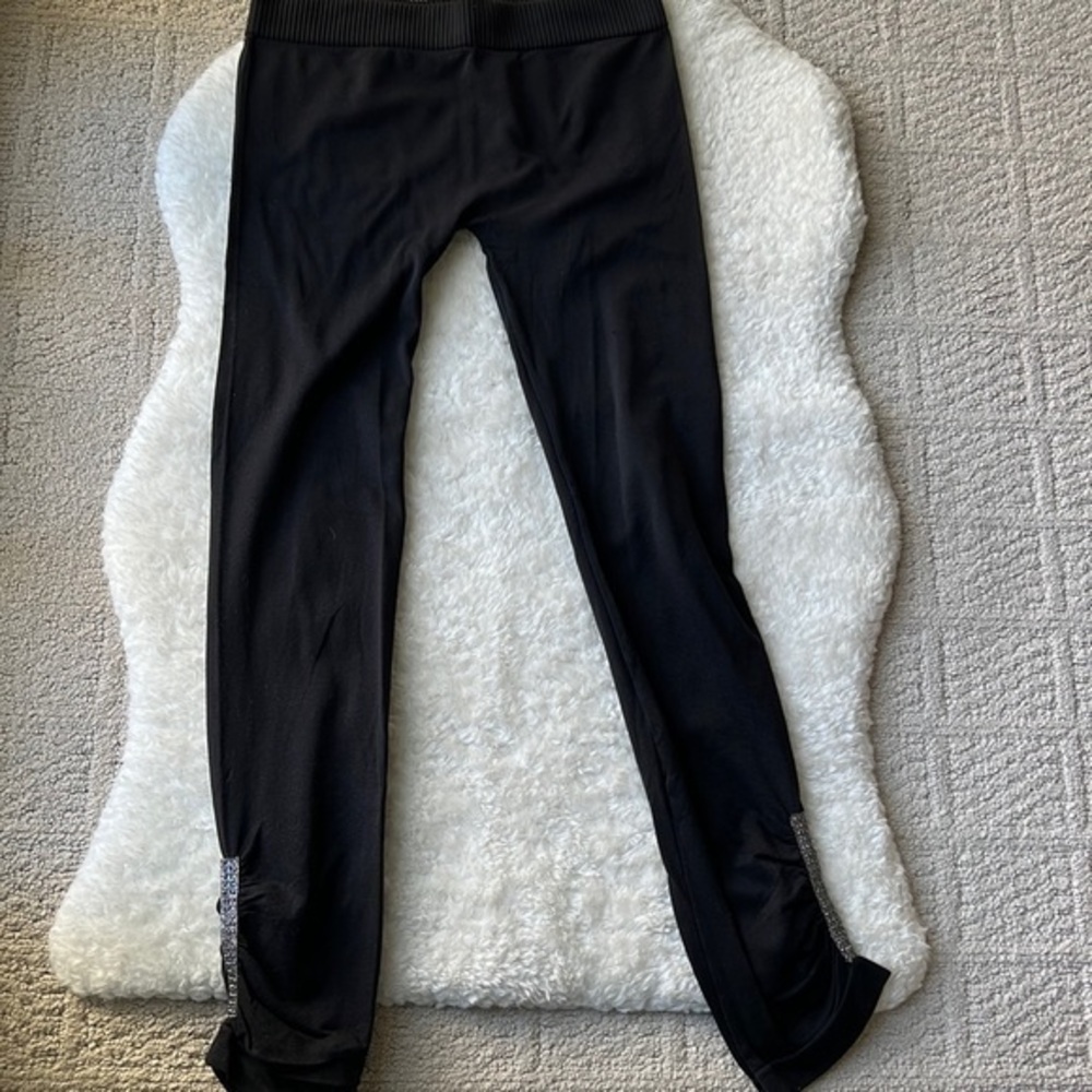 Vintage black leggings with silver stud detail at ankles